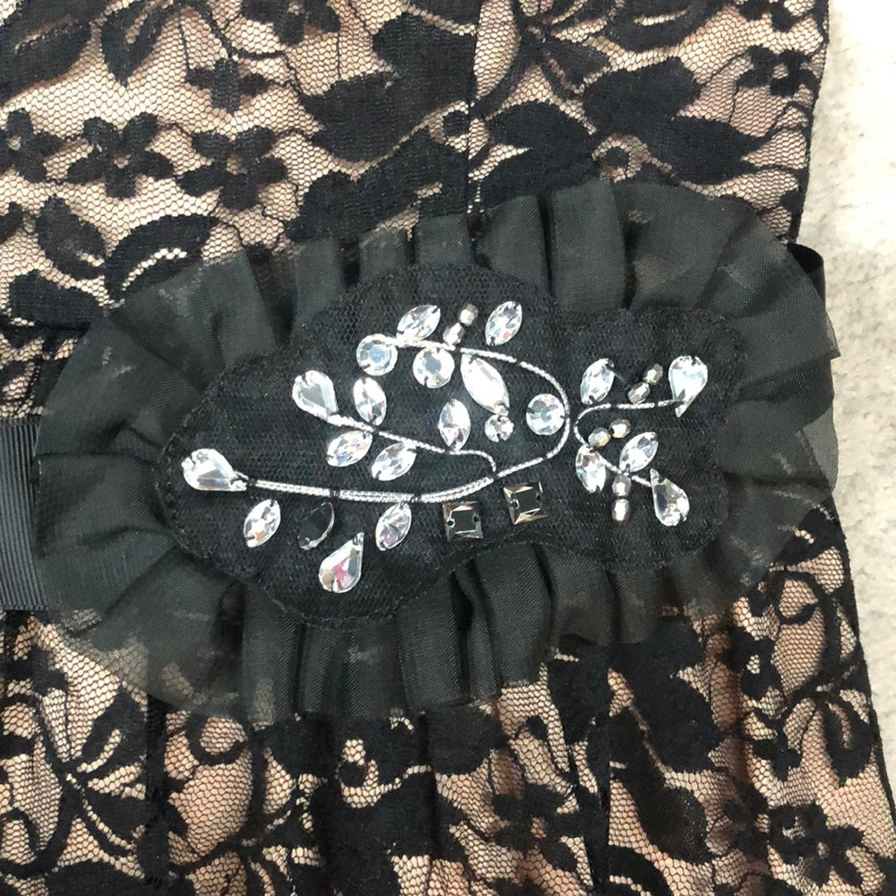 Black lace overlay over nude short formal dress