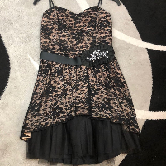 Black lace overlay over nude short formal dress