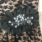 Black lace overlay over nude short formal dress